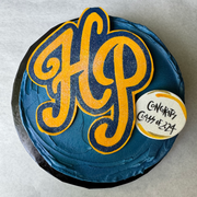 Cades Cakes round cake with Texas high school graduation theme