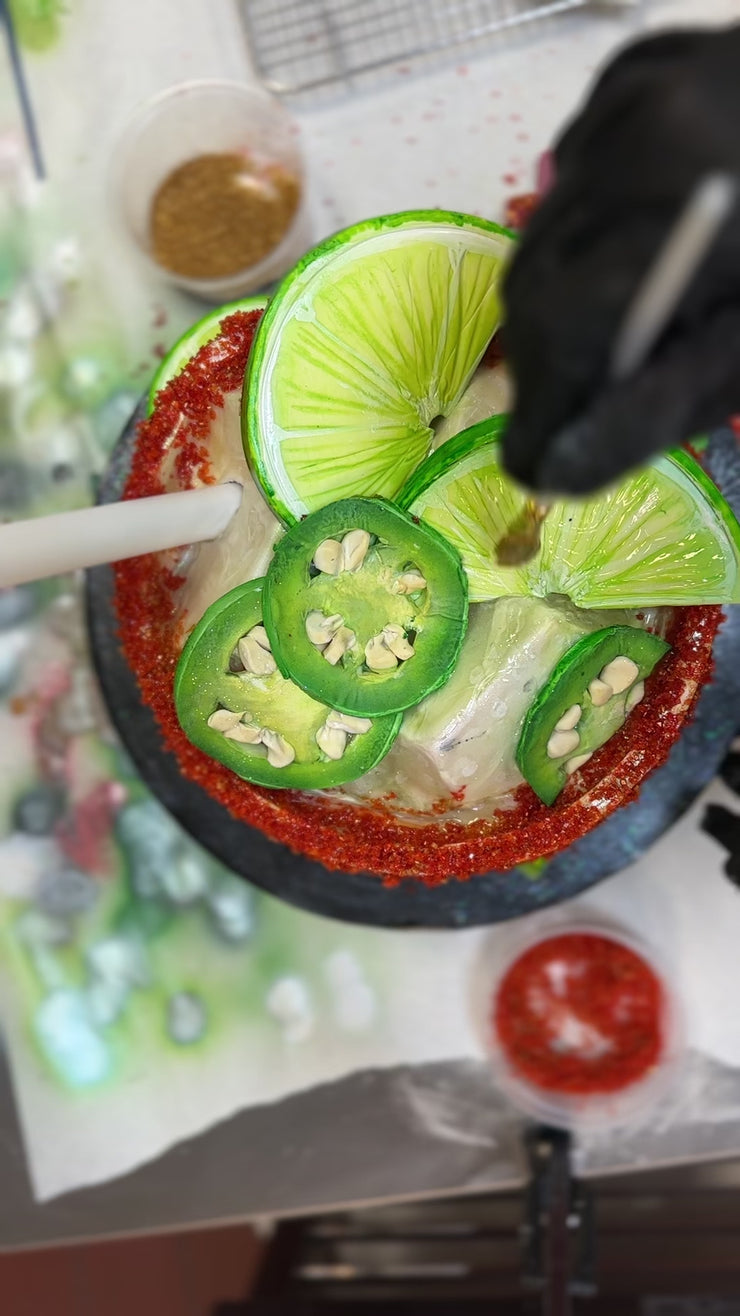 Decorating the limes and jalapeños on a spicy ranch water cake